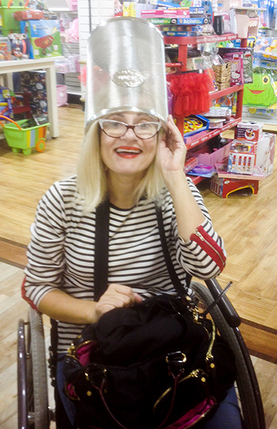 Wheelchair disabled blogger with trash bin on her head