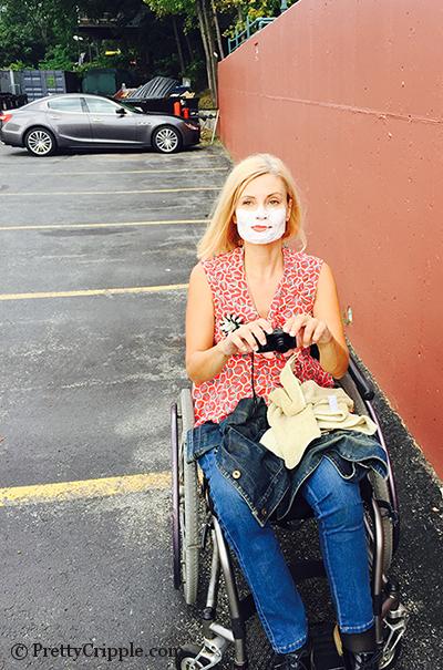 wheelchair blogger with shaving cream on her face in a parking lot.
